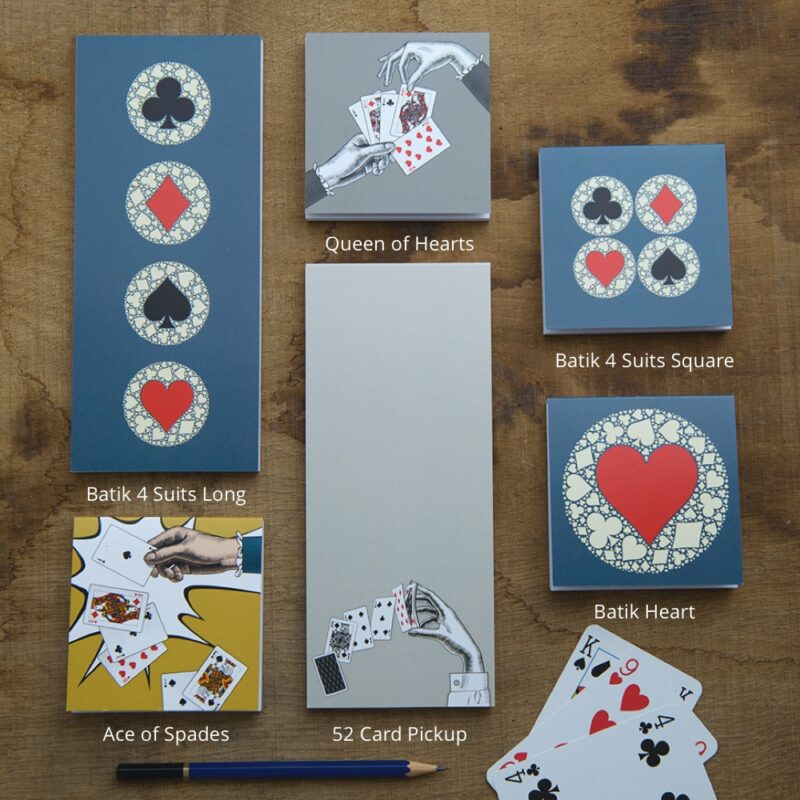 playing card themed notepads on wood with titles